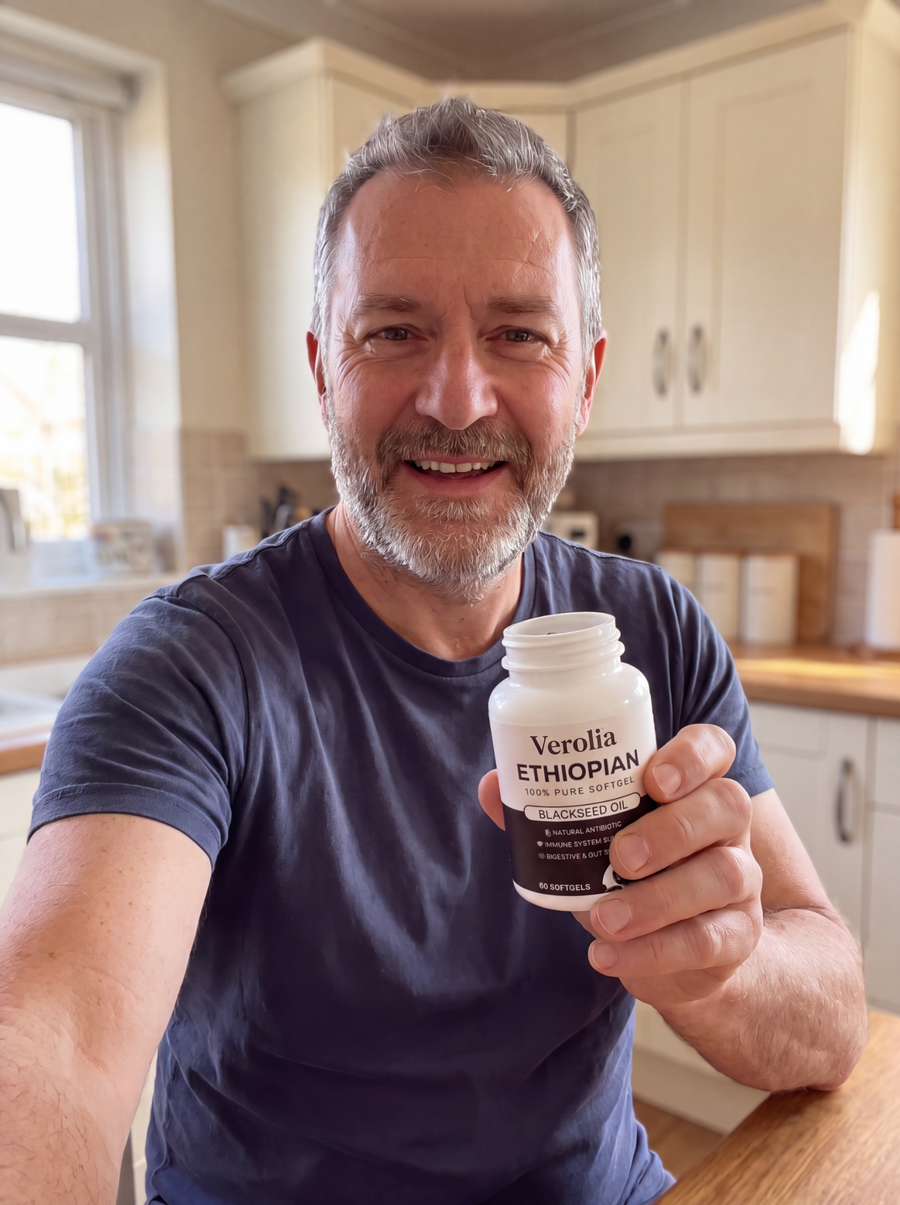 Marcel T. holding a Verolia black seed oil bottle